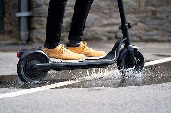 e scooter wheels going through a puddle 