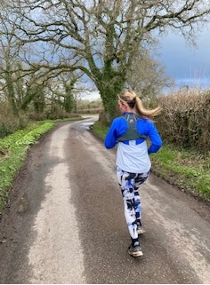 Bamboo running jacket and leggings worn by a woman on a country road