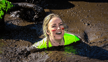 Woman in mud doing the Tough Mudder